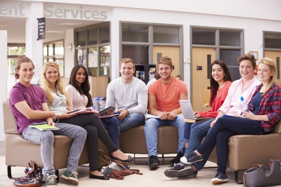 Group Of College Students Sitting And Talking Together