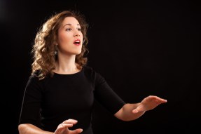Female choir conductor during performance